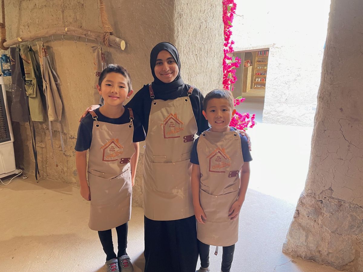 Children learning traditional pottery in Nizwa, Oman